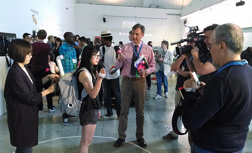 Ji Won Jun (far left) demonstrates her Data Vaporizer project to the press.