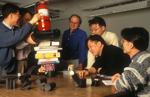 In this photo from the mid-'90s, Bruce and his IDS product design class test engineering principles of paper chair concepts.